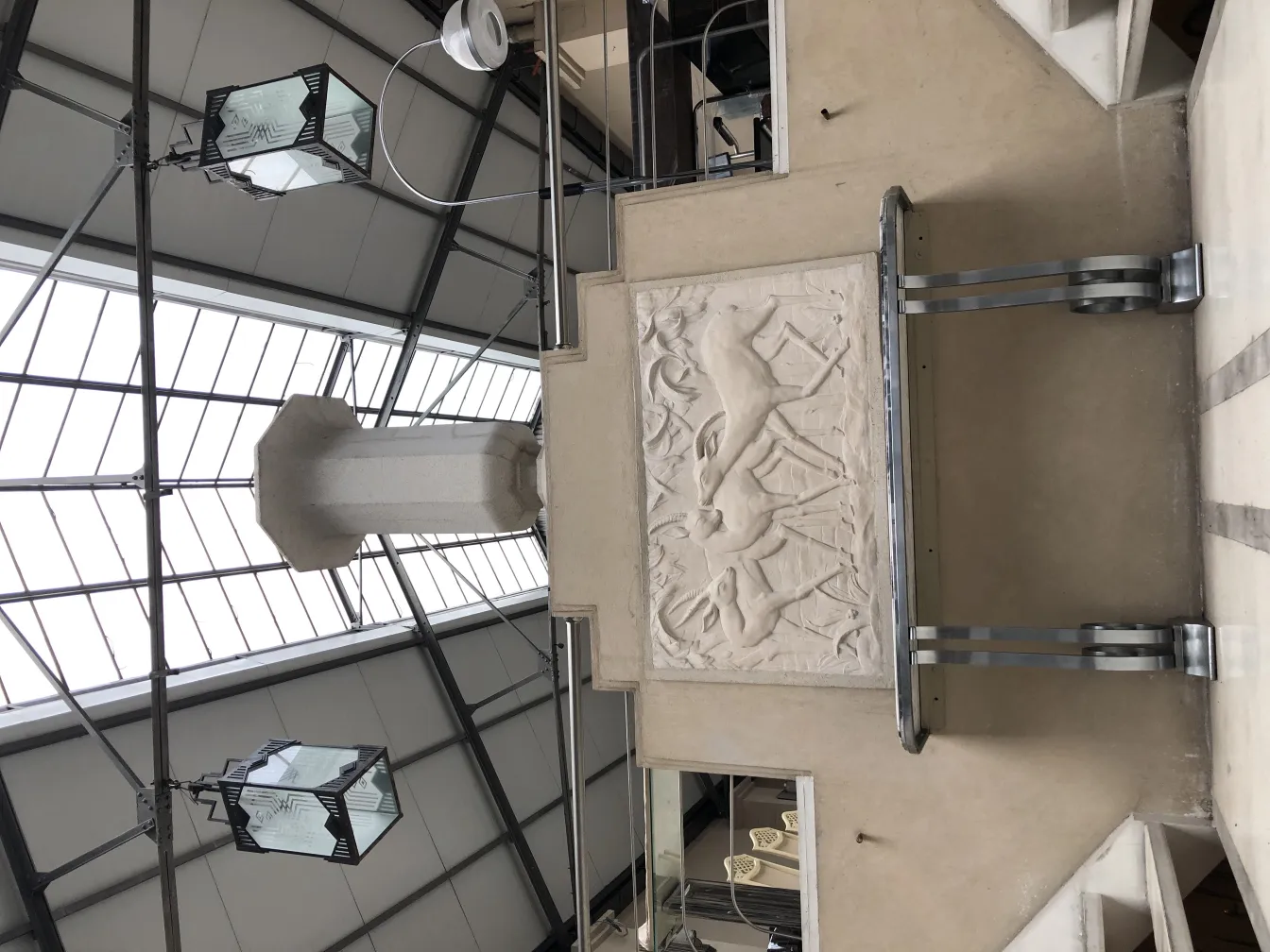 Antique decorative goblet in a modern architectural setting.