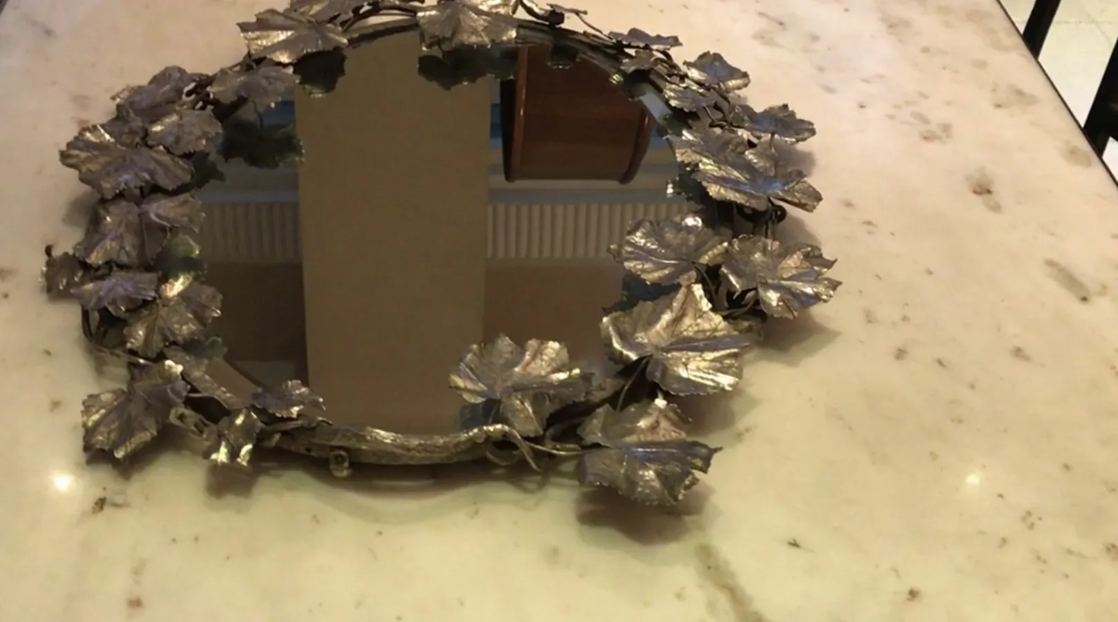 Antique tray featuring leaf decorations on the edge