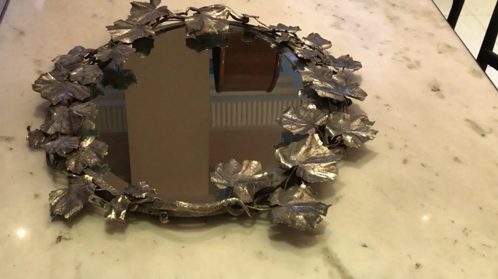 Vintage tray adorned with leaf design placed nicely.