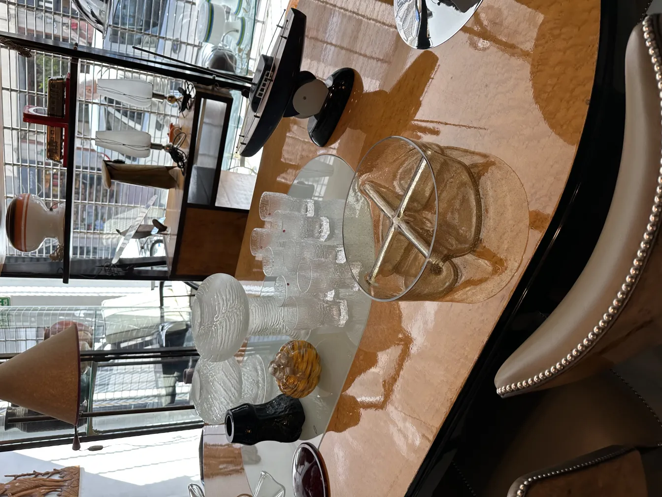 eight tapio wirkkala glasses displayed in an antique setting