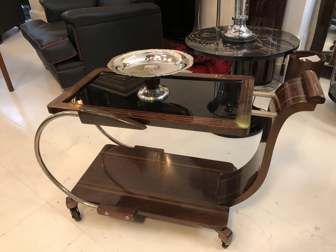 Antique pastry plate on a stylish cart in a modern setting.
