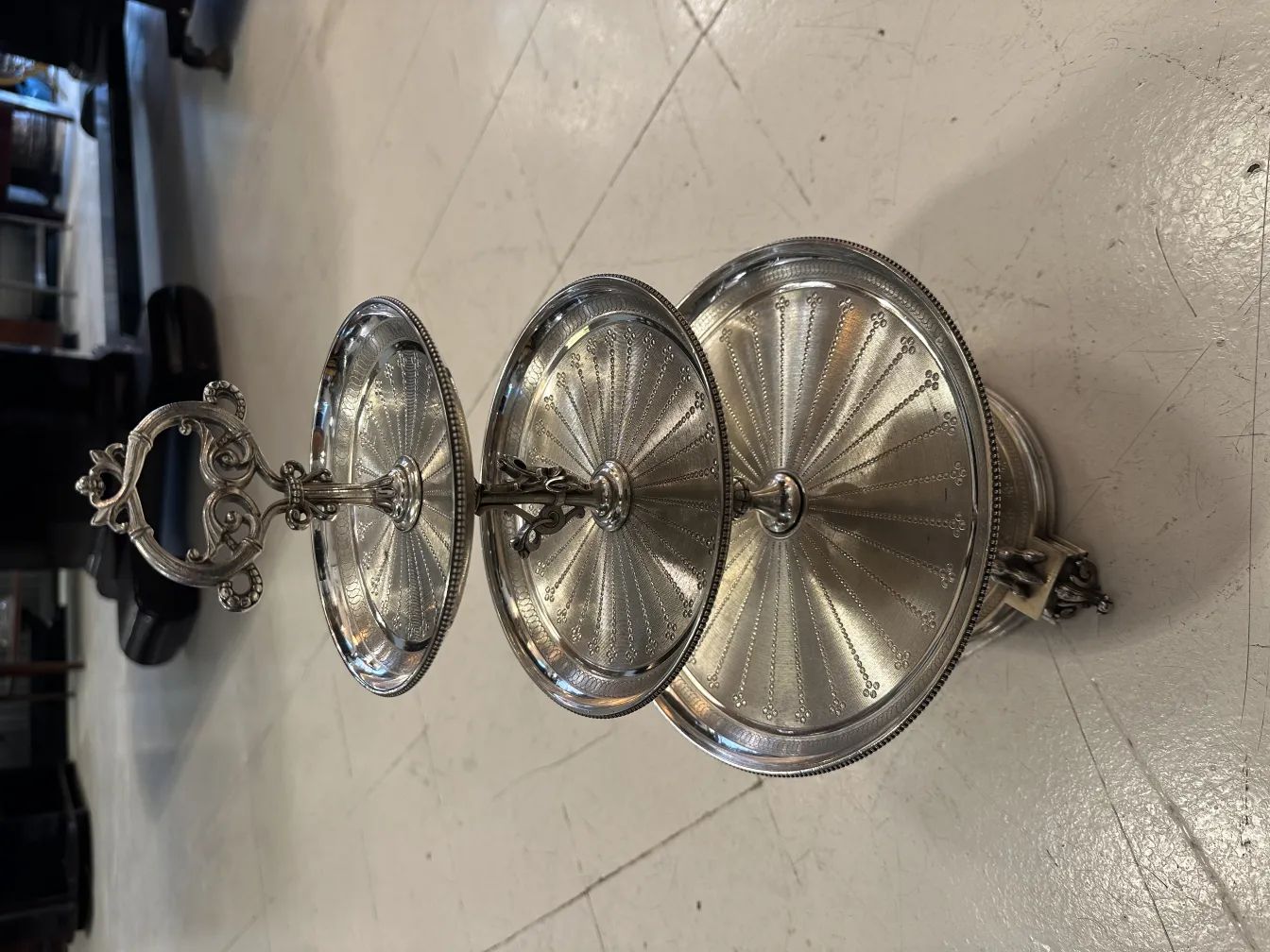 Antique three-tier pastry plate with elegant design, perfect for serving sweets.