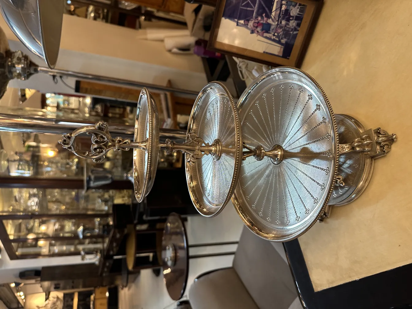 Elegant three-tier structure for serving desserts, featuring detailed edges.