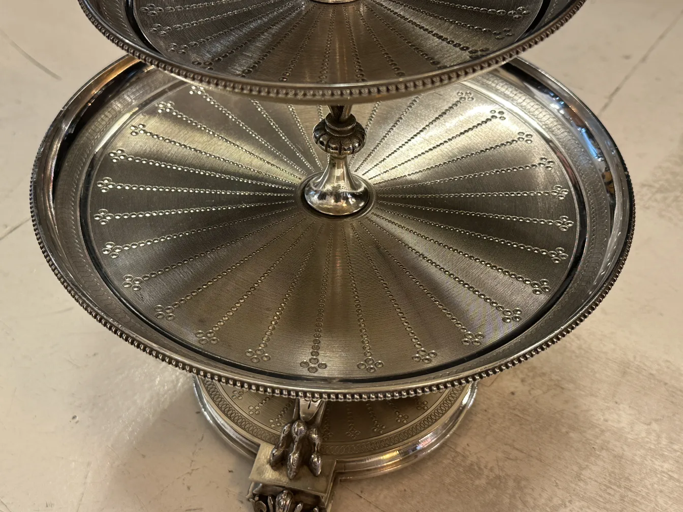 Antique pastry plate with detailed design and two levels, perfect for confections.