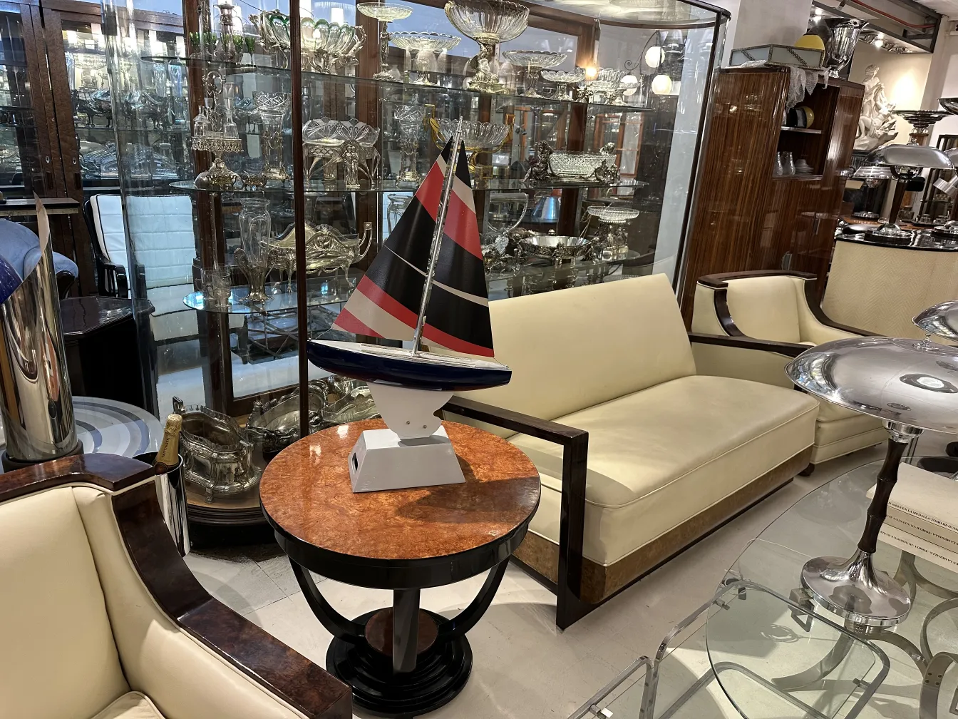 Barca del designer antico con bandiere, in un ambiente di antiquariato