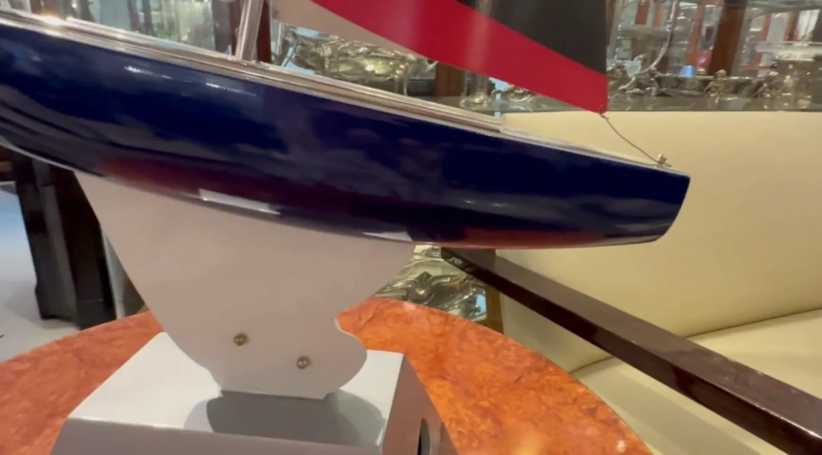 Barca del designer esposta in vetrina, colore blu e rosso.