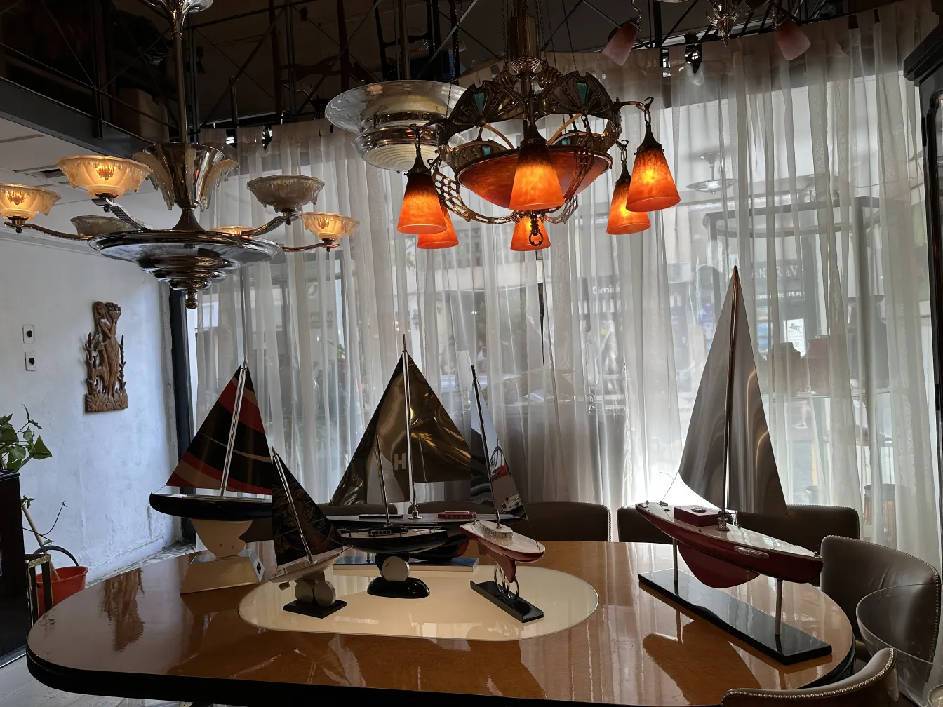 Antique model of designer's ship with various colors and a lit background.