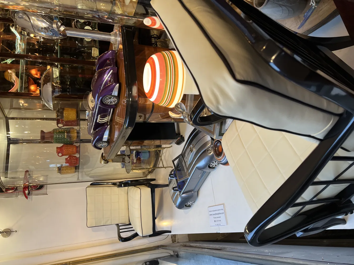 Antique car of designer Marcelo Peña displayed with modern chairs and retro decor.