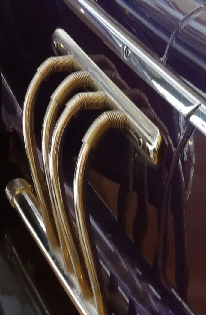 Detail of the rear of an antique car with metallic features