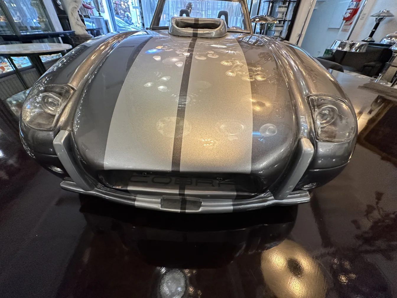 Antique car of designer Marcelo Peña, gray with stripes.