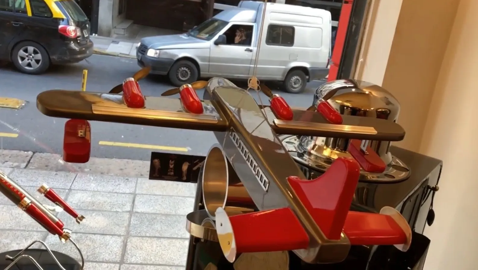 Modello di aereo antico del designer Marcelo Peña, rosso e argento.