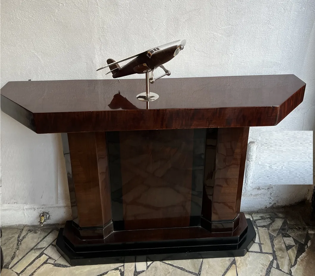 Antique airplane sculpture by designer Marcelo Peña on a stylish table.