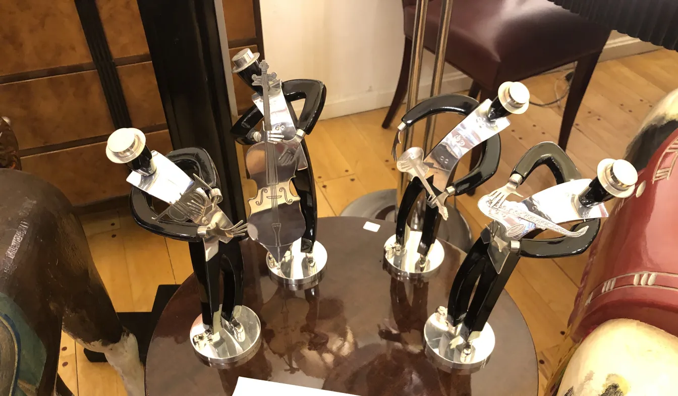 antique sculptures of a music band on a table