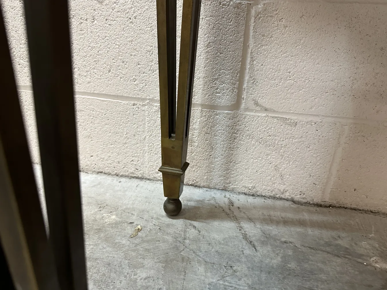 detail of antique console legs in a neutral setting