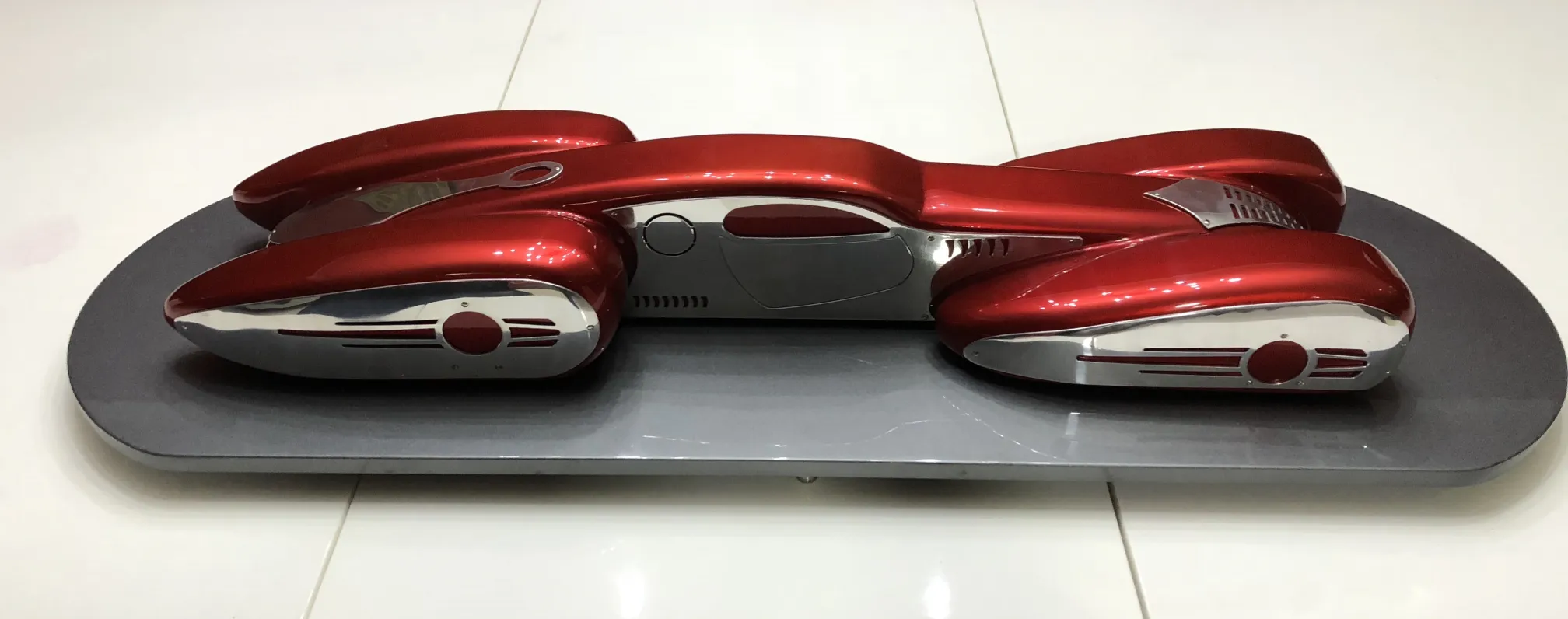 Antique car by designer Marcelo Peña in shiny red color.
