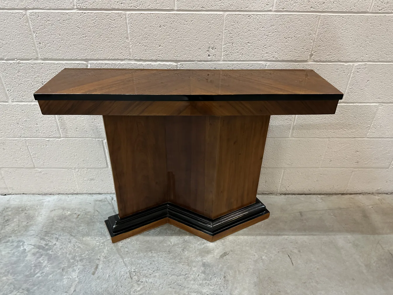 Duas consoles antigas com design decorativo em um ambiente neutro.