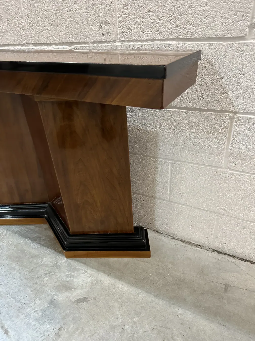 two antique consoles with an elegant finish in a neutral setting