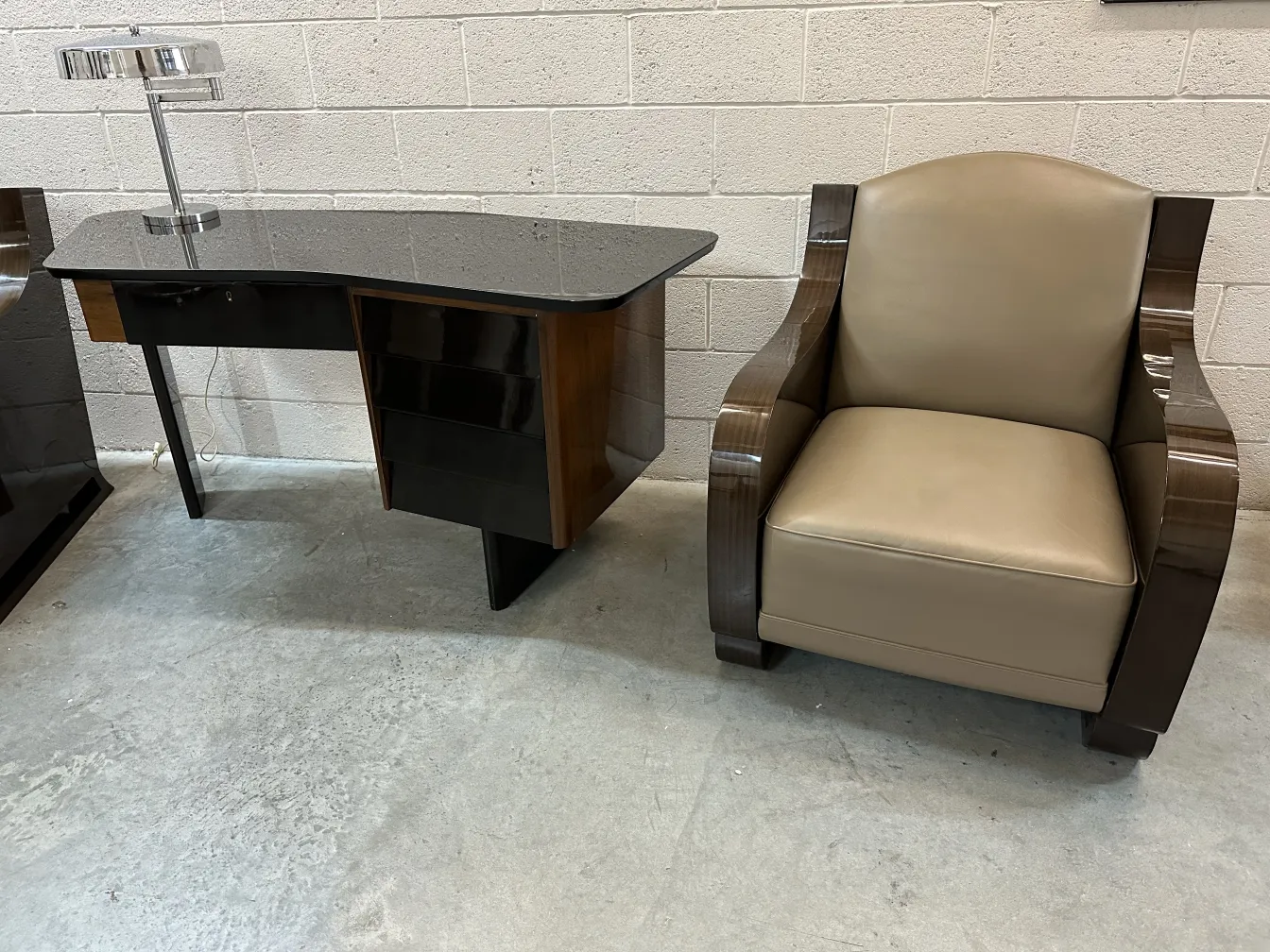 Antique desk with a shiny surface and a lamp.