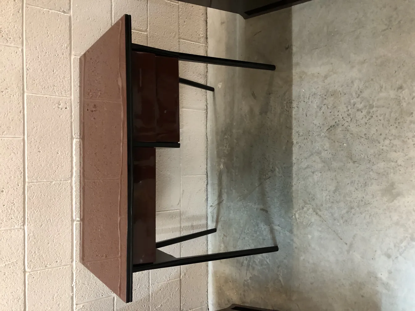 Antique desk with black structure and drawers, smooth surface