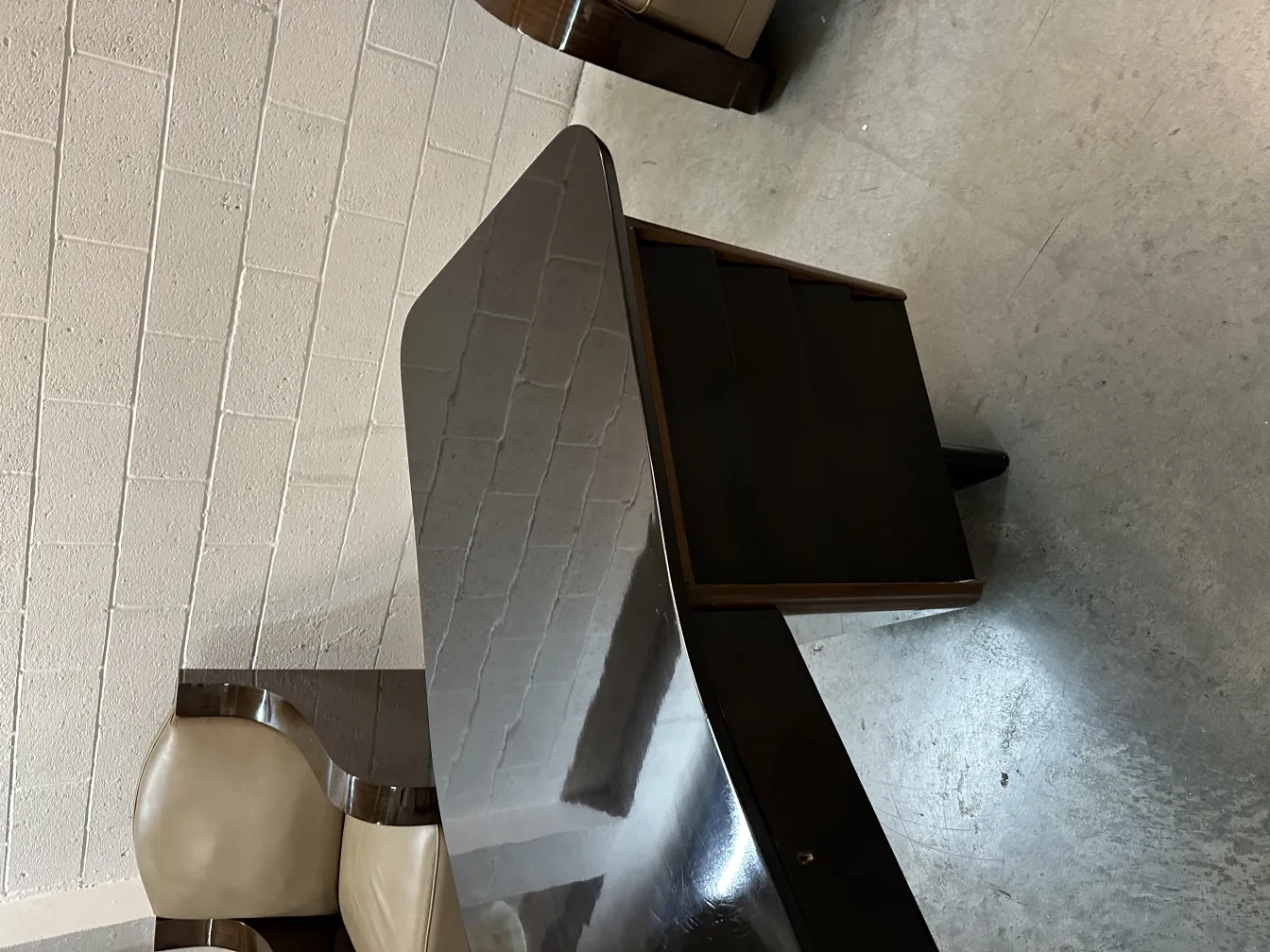 antique desk with elegant legs and glossy surface