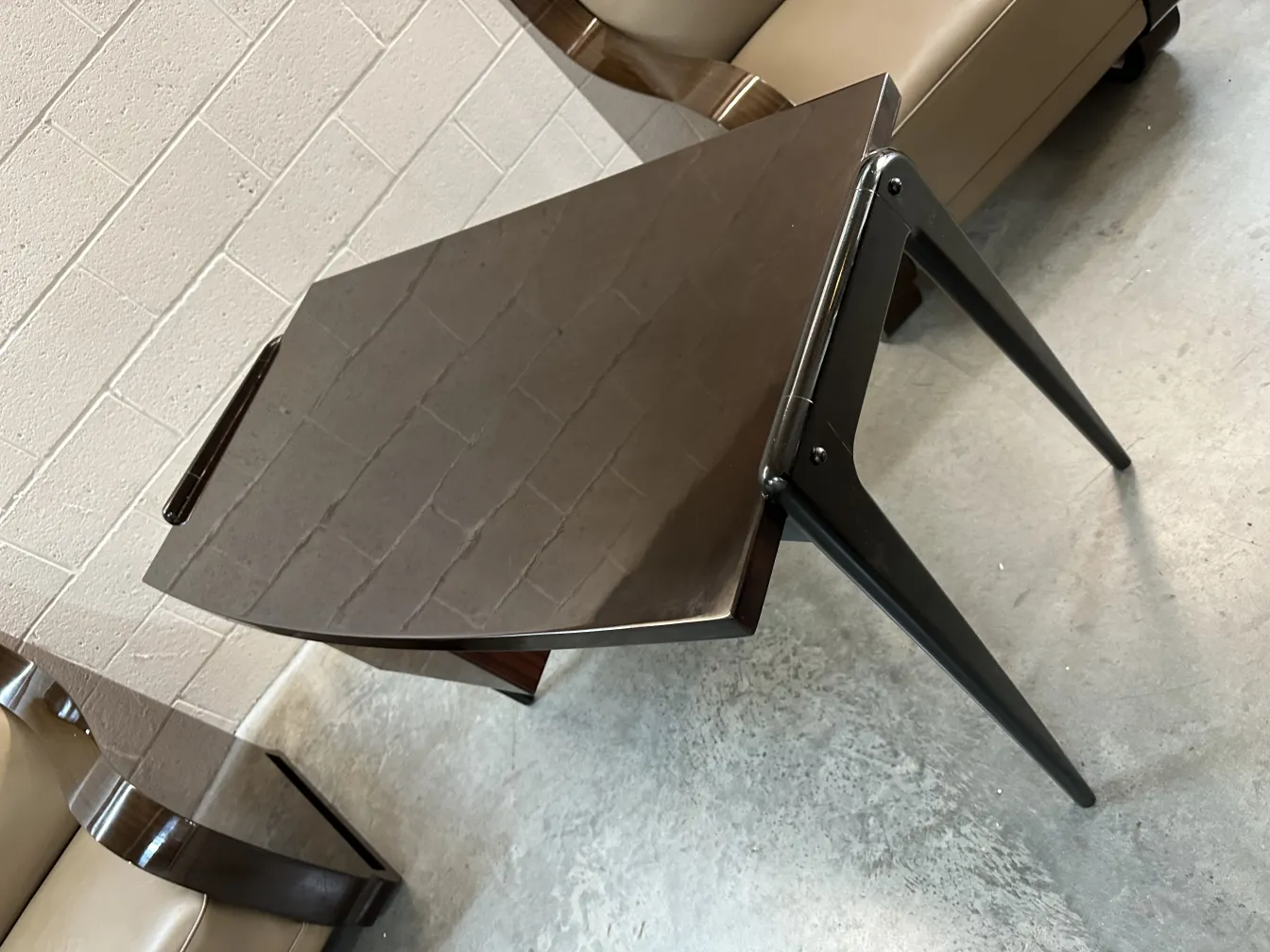 Antique desk with a sleek surface and thin legs in a contemporary setting.