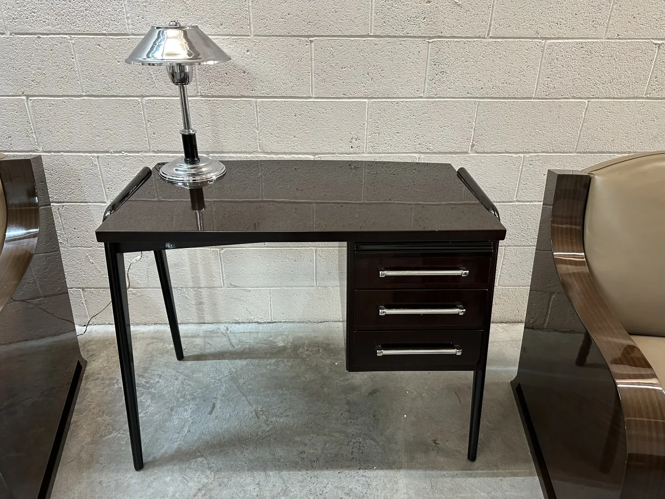 antique desk with a lamp and drawers