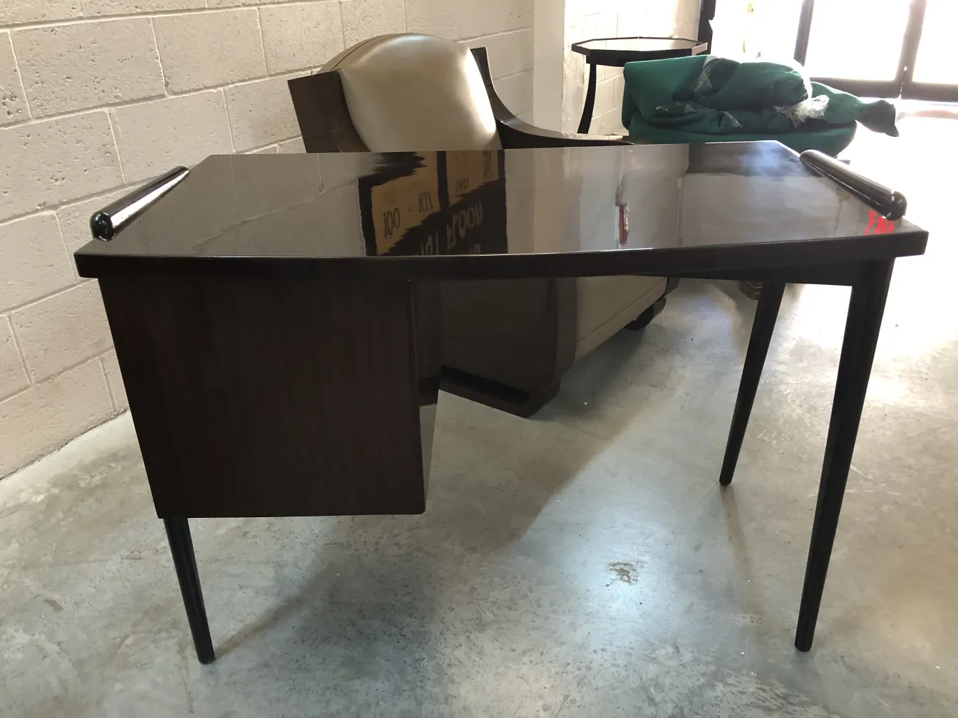 antique desk with functional design, featuring slender legs and polished surface