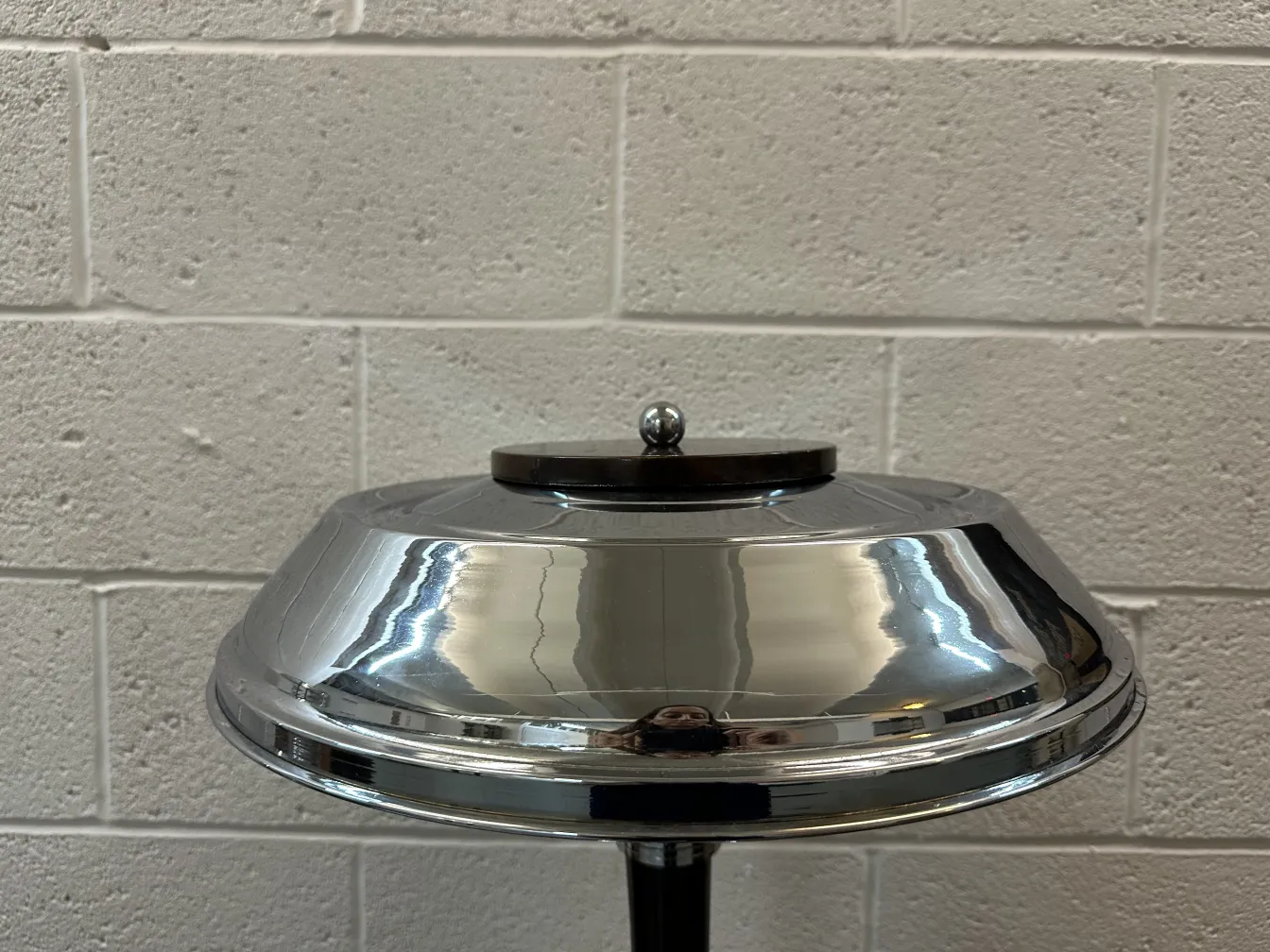 View of 2 shiny antique table lamps in a simple setting