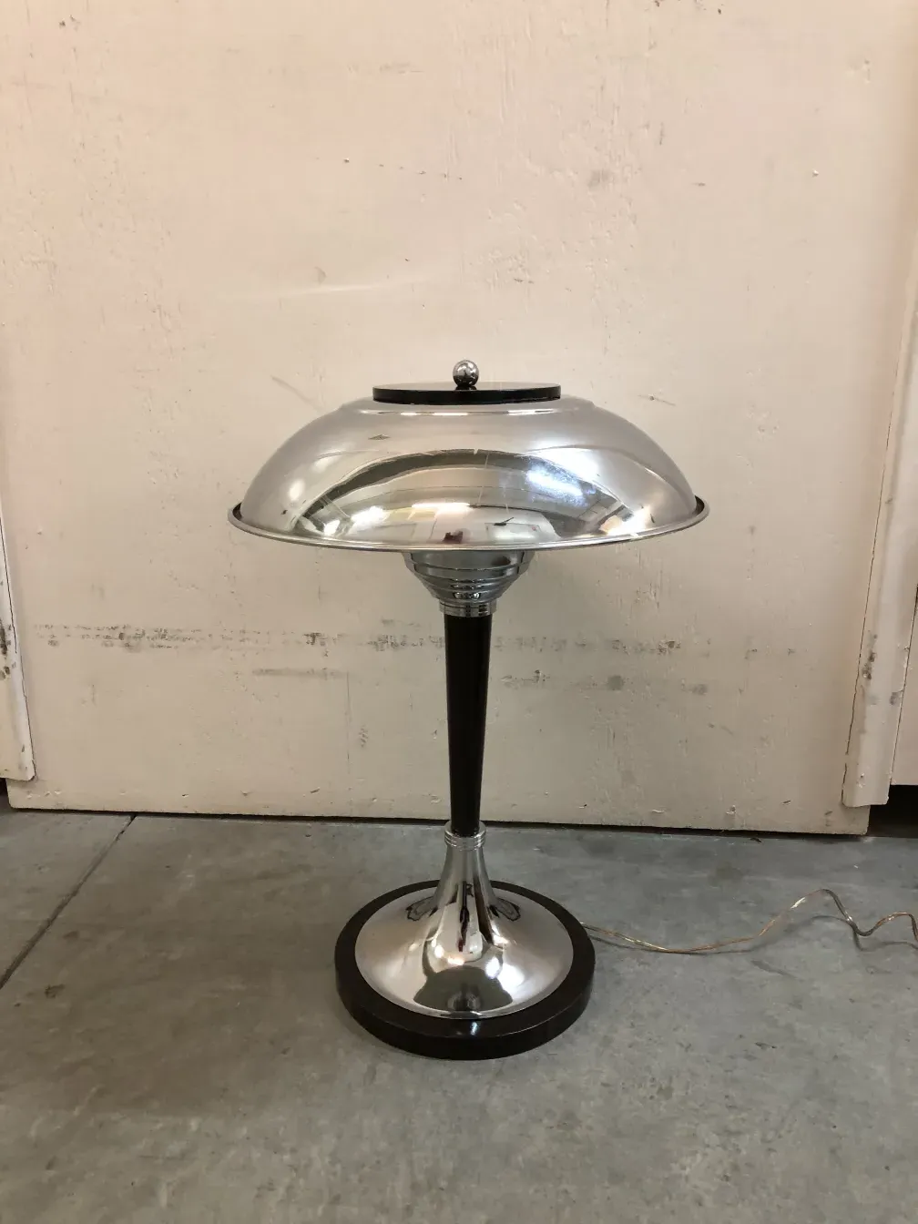 2 antique table lamps with shiny finishes in a simple setting