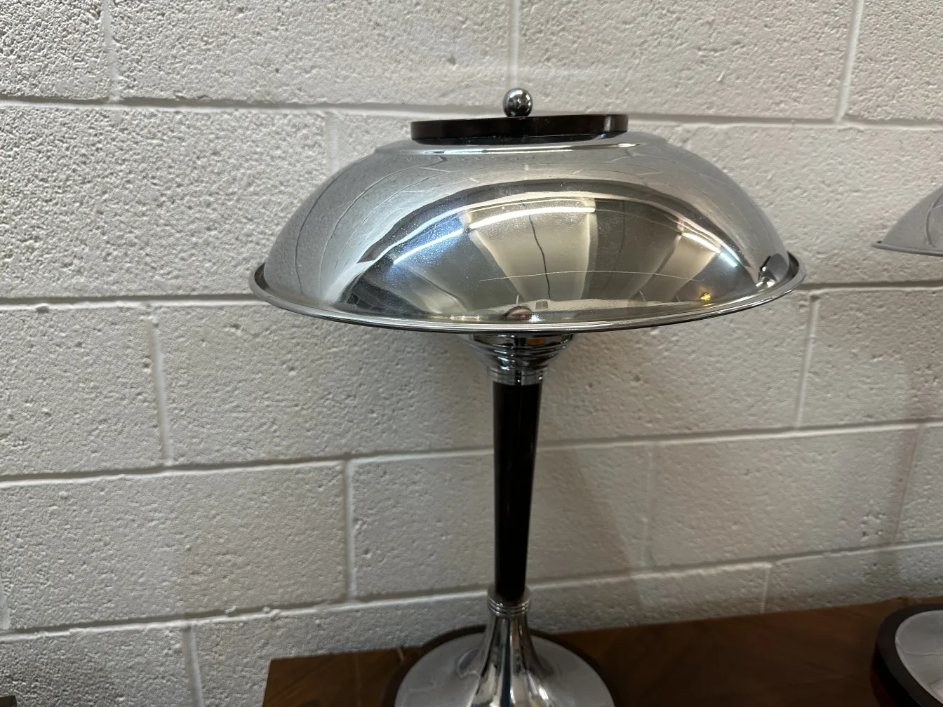 2 antique table lamps with elegant bases and shiny shades, set in a modern environment.