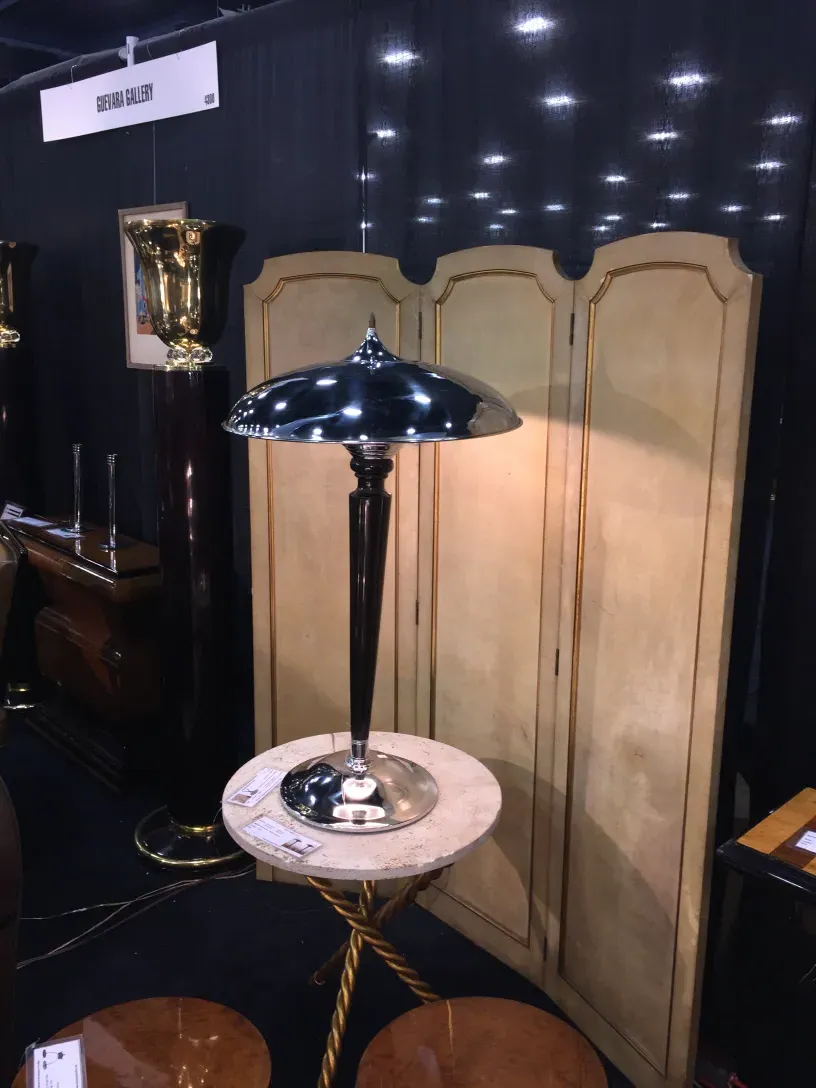 Deux lampes de table anciennes avec des bases élégantes, entourées d'autres éléments décoratifs.