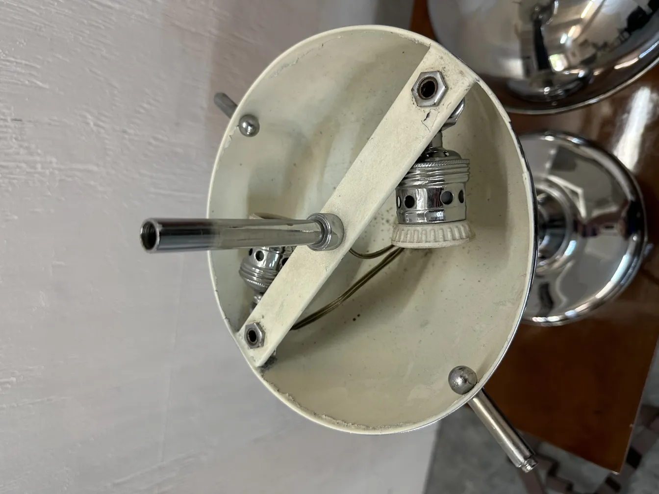 Top view of an antique table lamp with white interior, visible details of the socket.