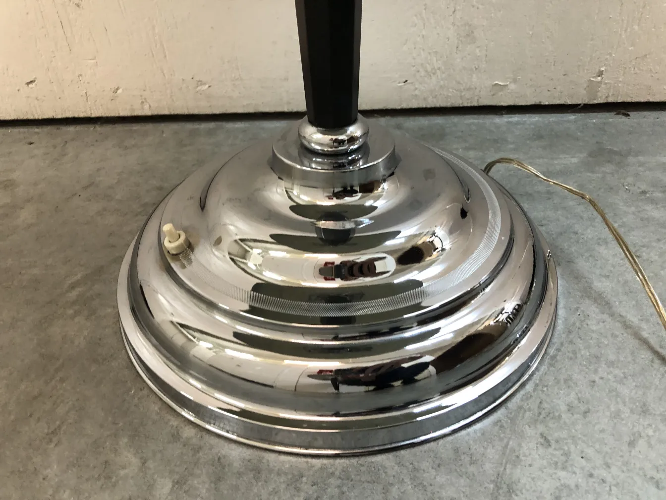 Antique table lamp with shiny metallic base and elegant design.