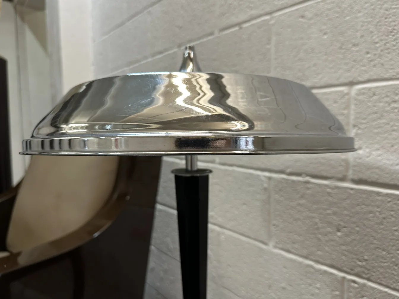 Lámpara de mesa antigua con sombrero brillante en un ambiente clásico.