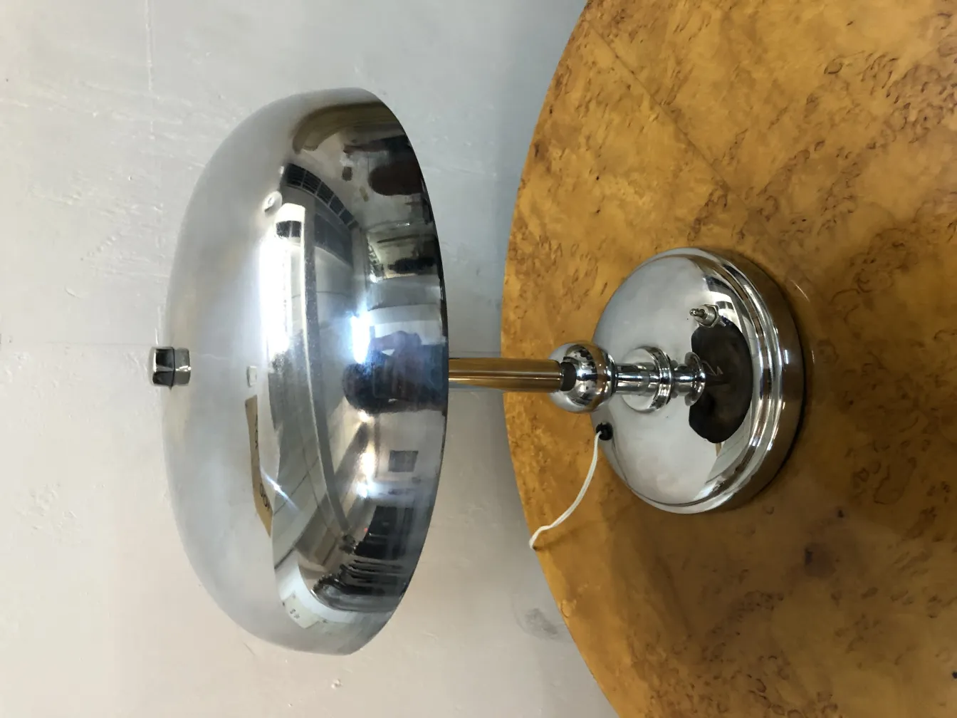 Antique table lamp with an elegant design and round base in a cozy setting.