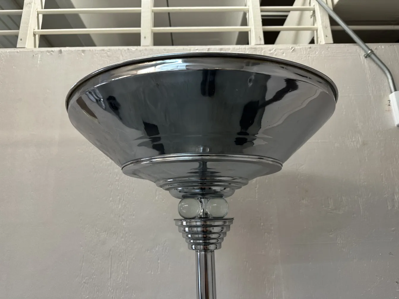 Vista di due lampade da terra antiche con basi classiche, ambiente luminoso.