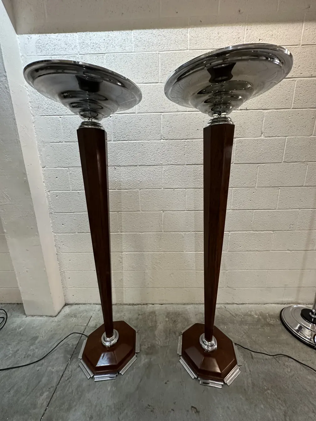 Two elegant antique floor lamps in a bright room.