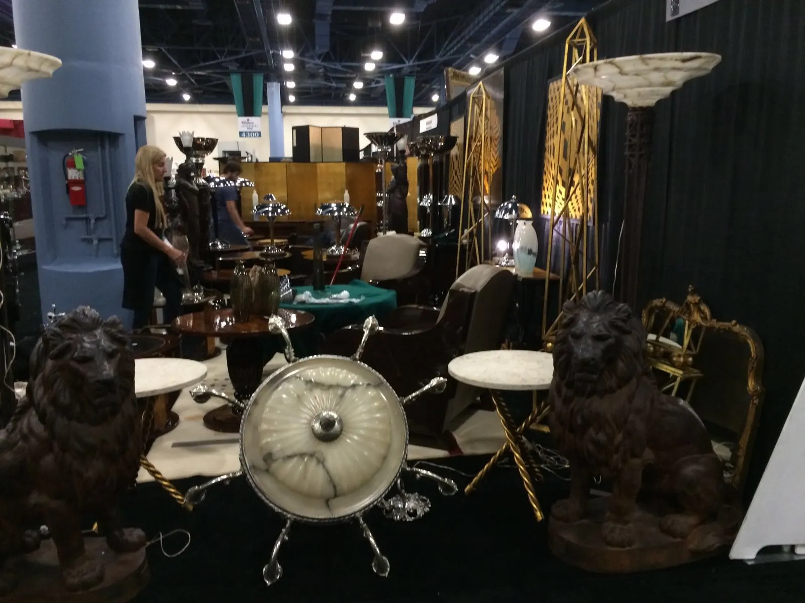 Two antique floor lamps featuring lion sculptures at the base.