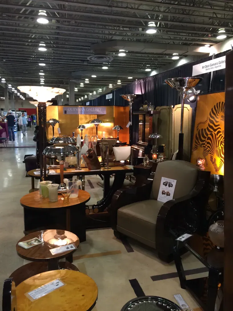 two antique floor lamps displayed in a modern setting