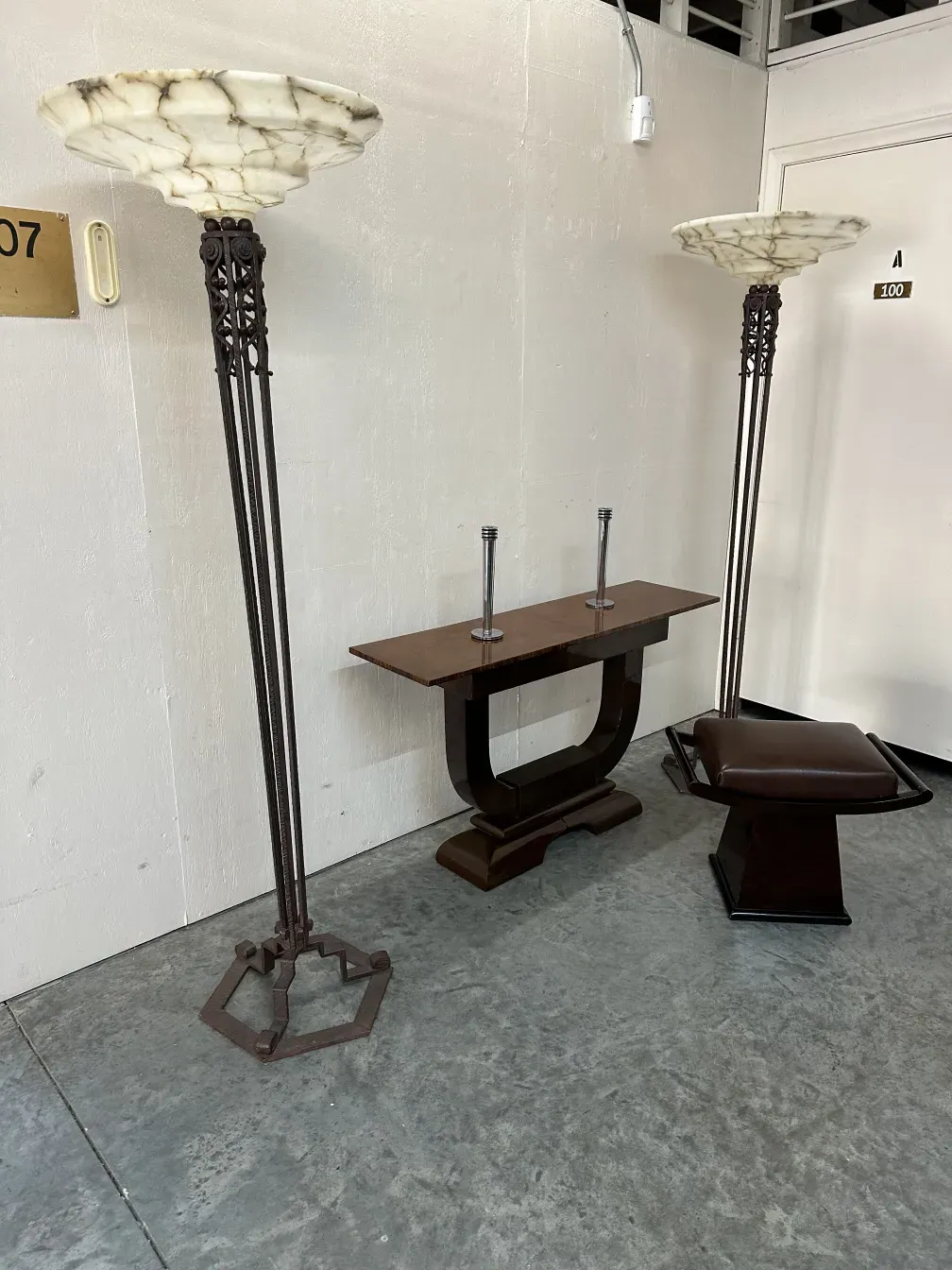 Antique floor lamps with ornate details and elegant base, in a subtle setting.