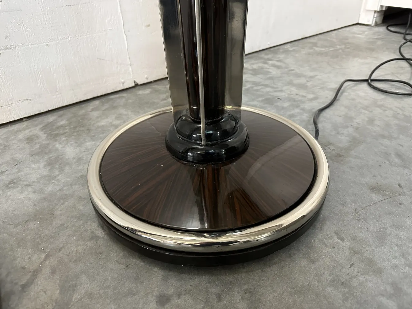 Antique floor lamp base with a sleek design in a modern setting.