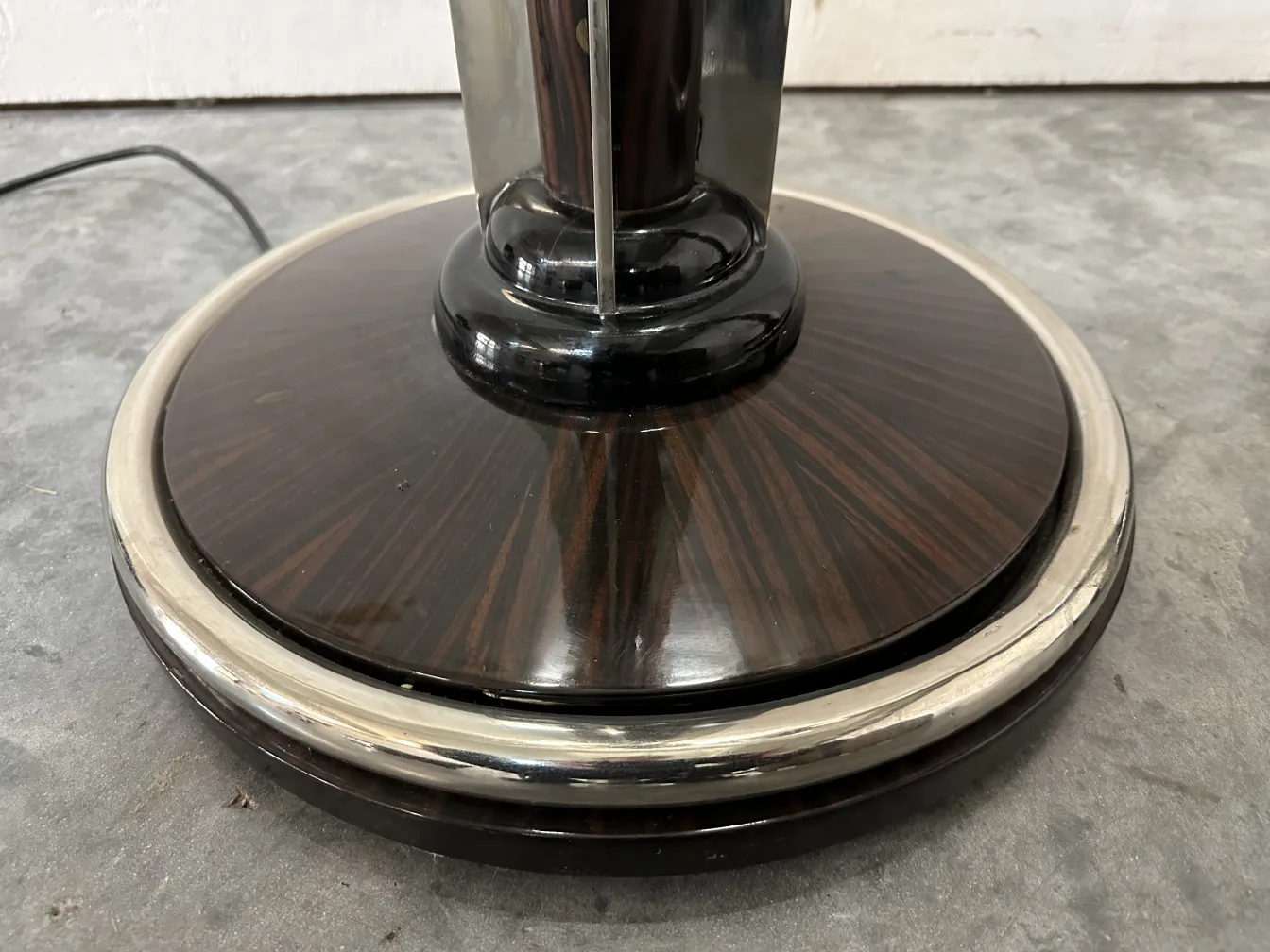 base of an antique floor lamp with elegant design in a neutral setting