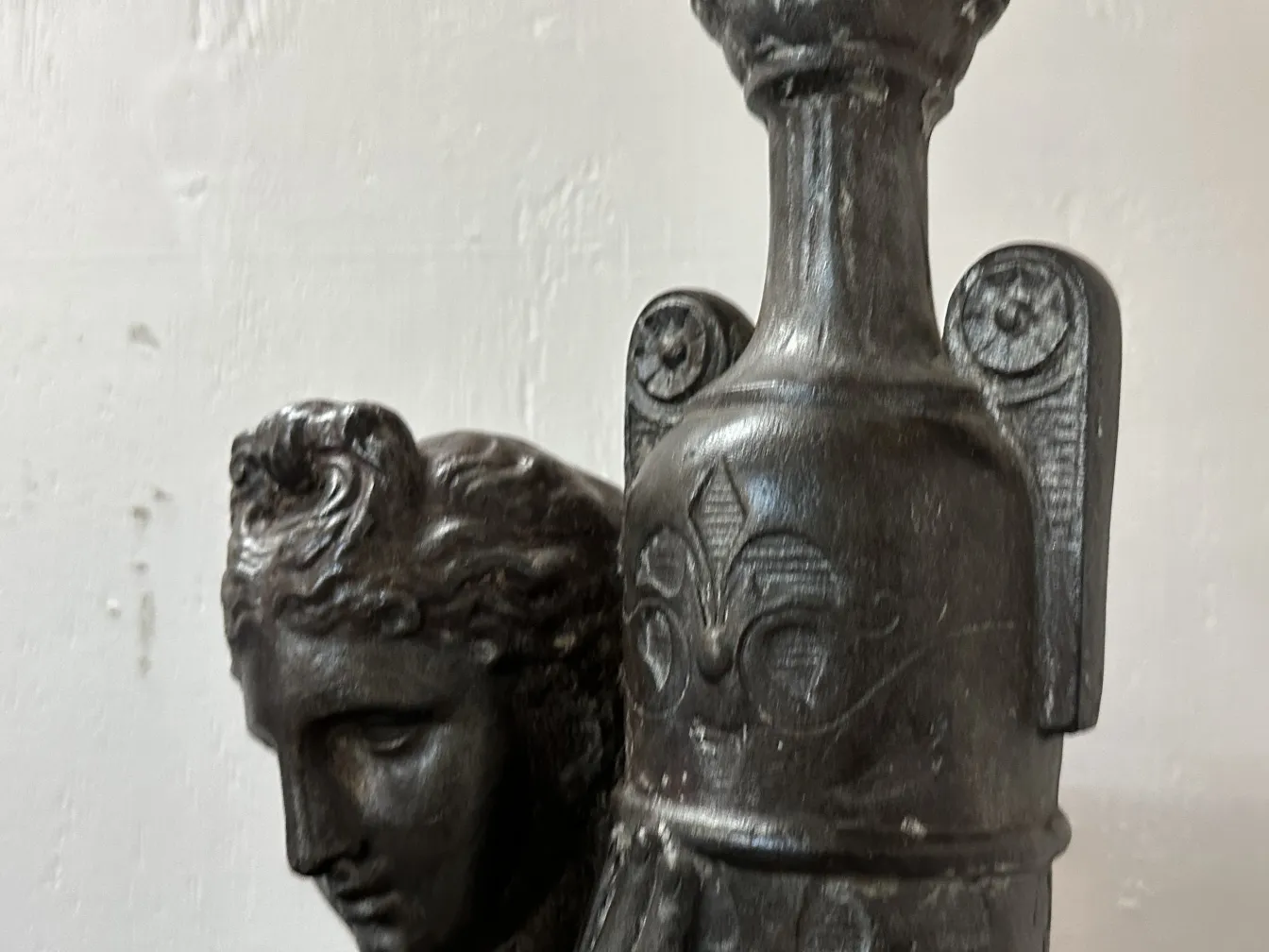 View of two antique floor lamps featuring base details