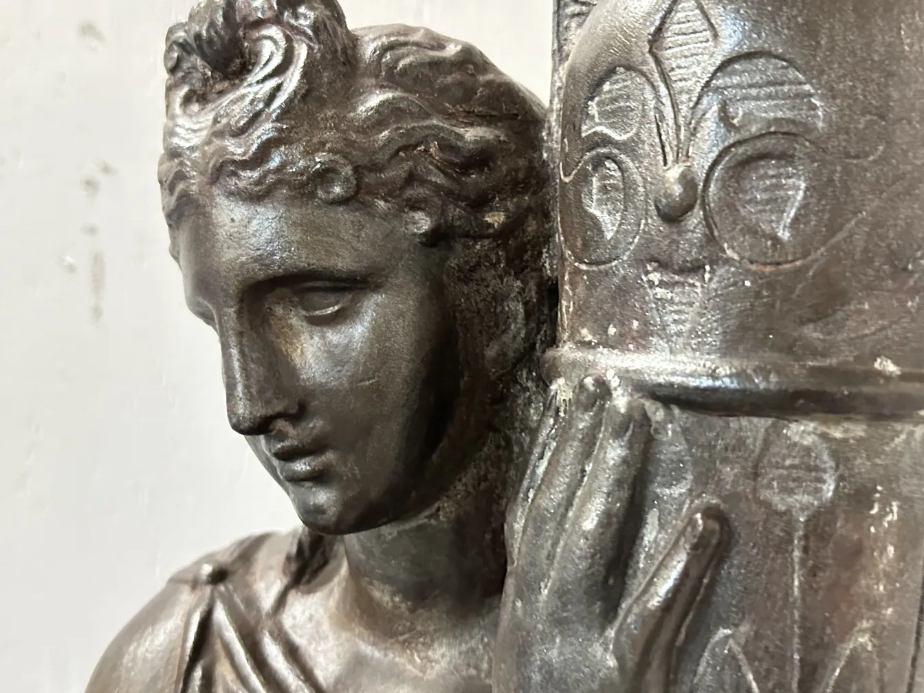 Detail of 2 antique floor lamps with decorative figure and embellishments.