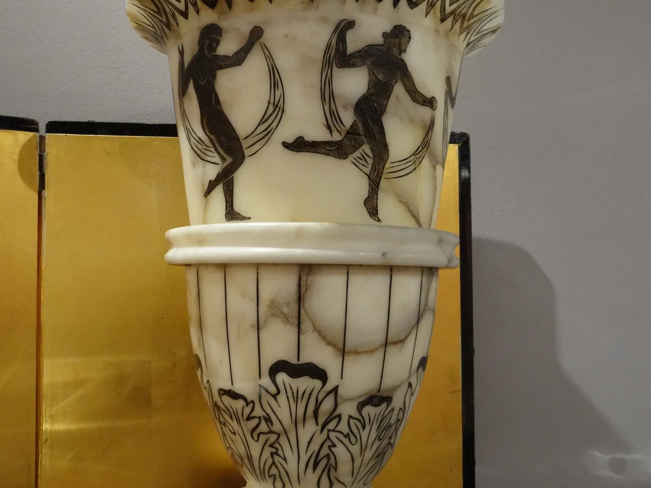 Lampada da terra antica con figure decorative in un ambiente accogliente.