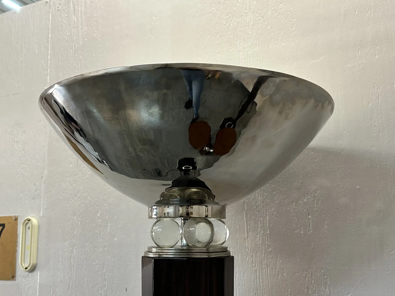 Close-up view of two antique floor lamps with decorative base