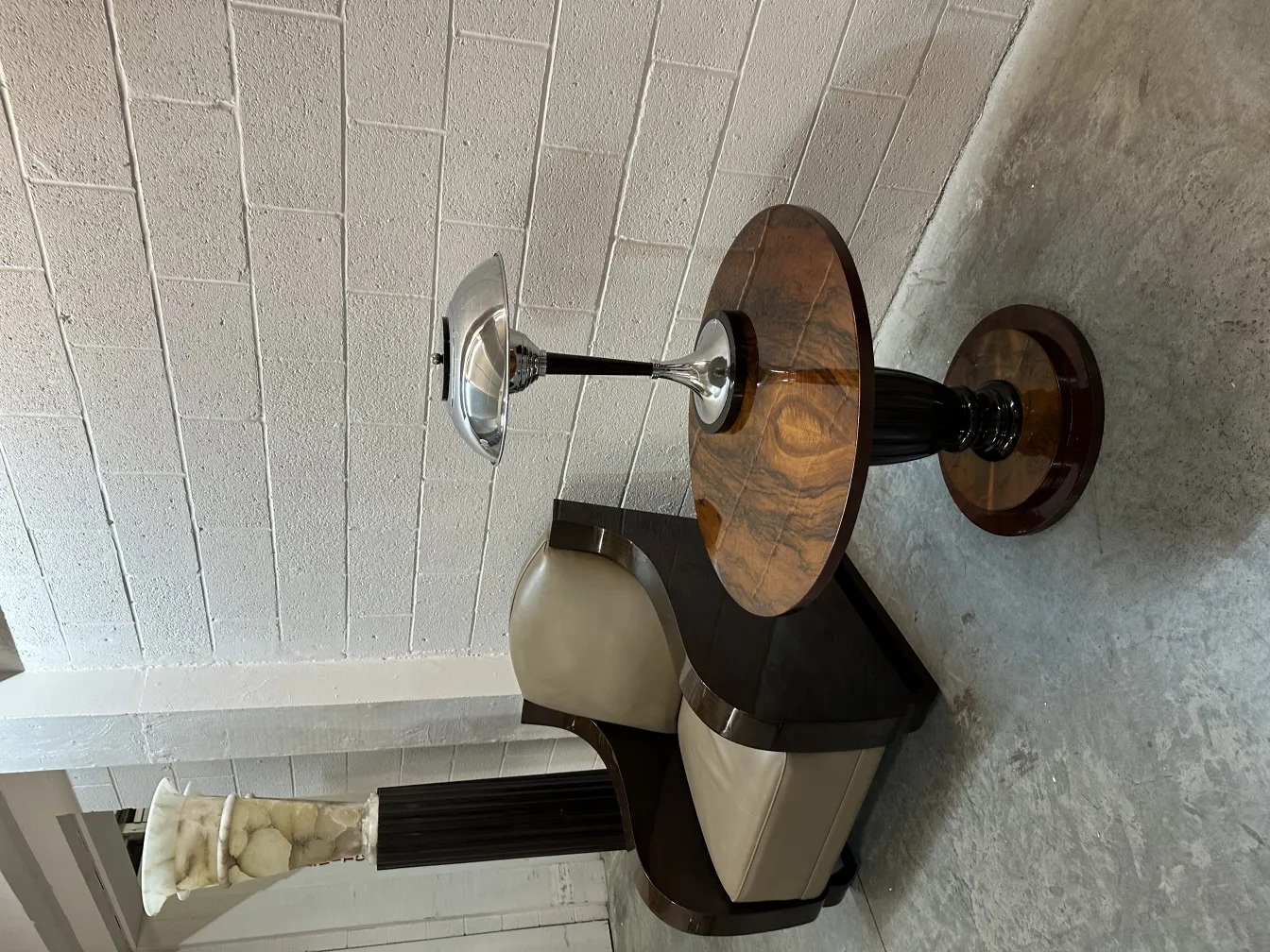 two antique floor lamps in an elegant setting, one lamp has a dark base and metallic shade.