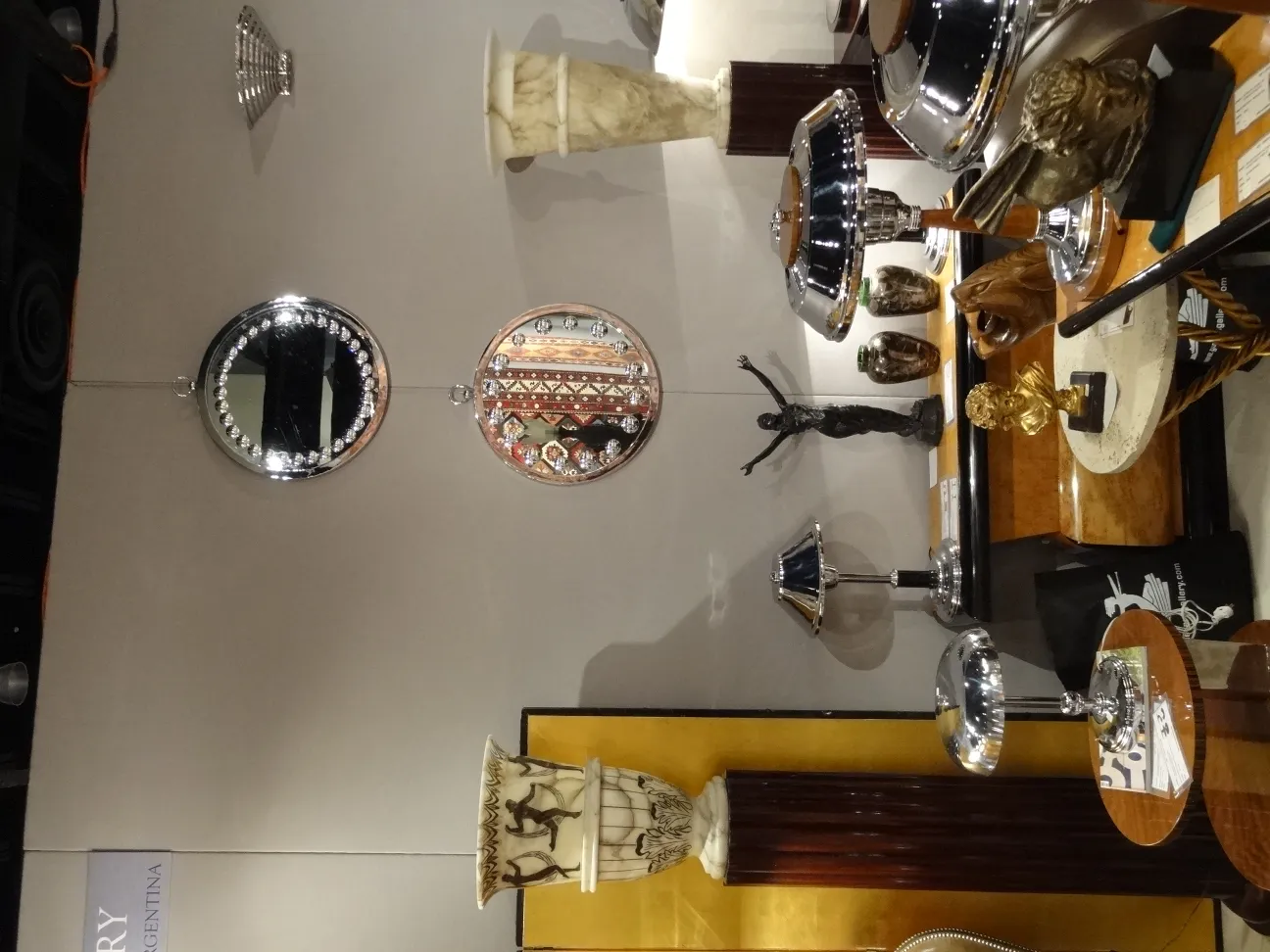 Detailed view of two antique floor lamps on display.