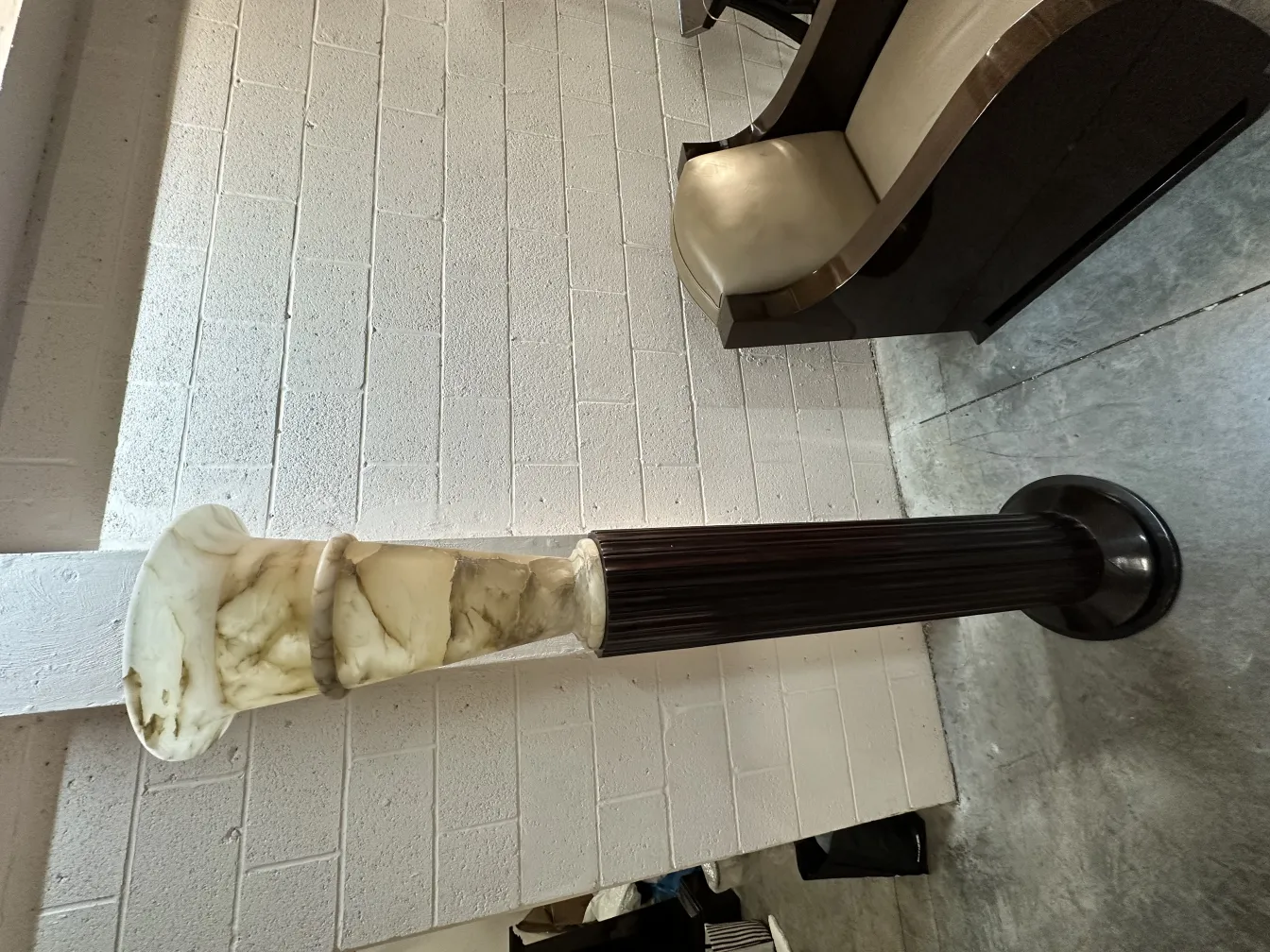 Two antique floor lamps with dark base and clear shade in a pleasant setting.