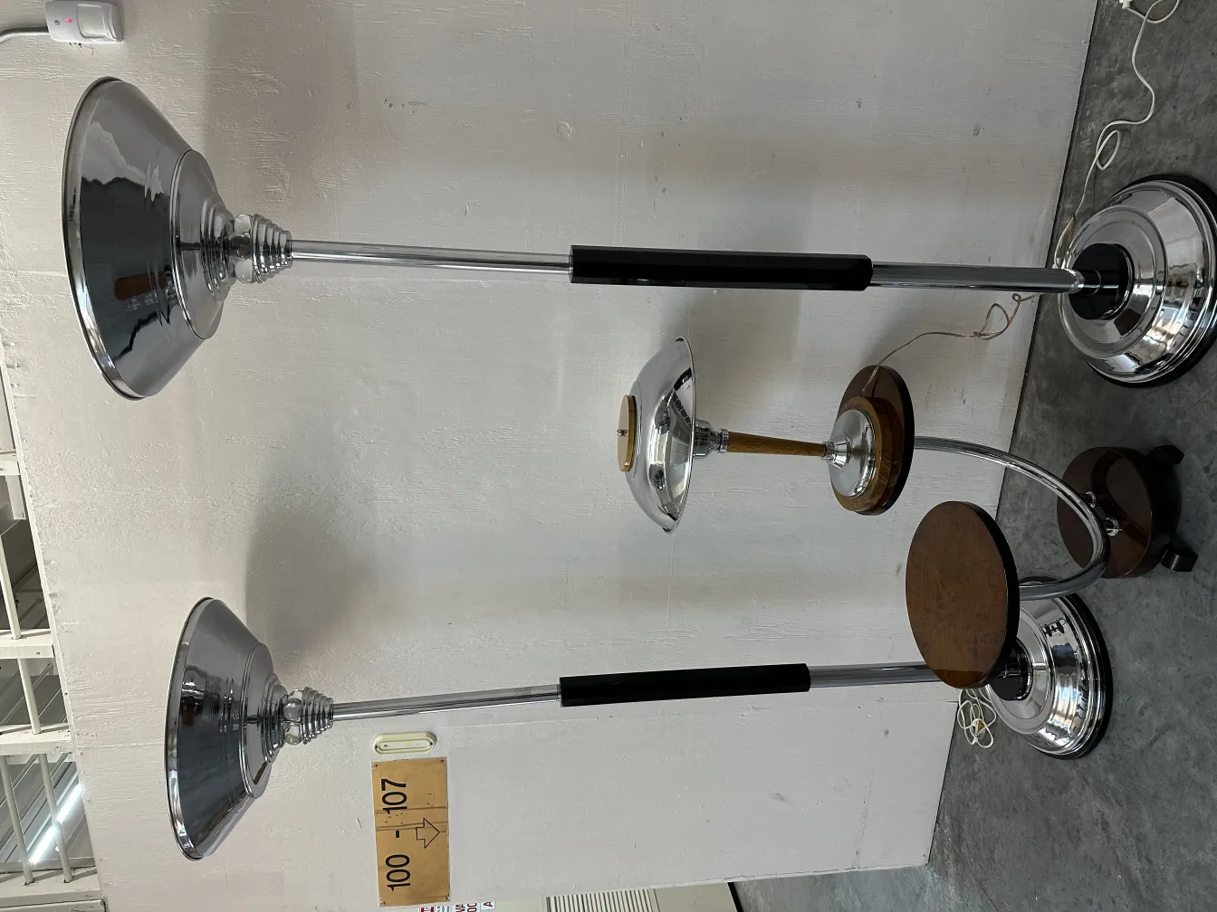 two antique floor lamps with round bases and elegant shades